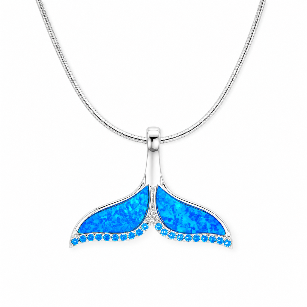 Sterling silver whale tail necklace featuring vibrant blue opal inlay and shimmering accent stones on a sleek silver chain, displayed on a pure white background.