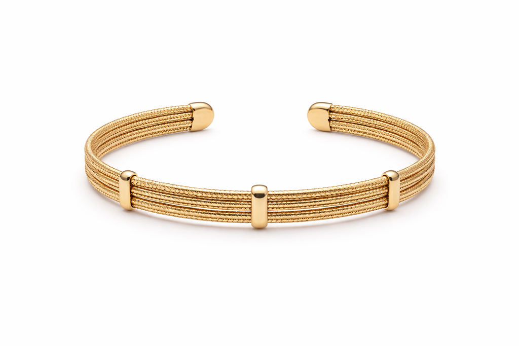 Elegant gold multi-line textured cuff bracelet worn by a modern bride standing beside a floor-to-ceiling hotel window while holding a bouquet of white roses. Soft morning sunlight, luxury bridal suite, satin wedding gown, and editorial wedding styling create a timeless bridal jewelry look.
