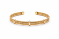 Elegant gold multi-line textured cuff bracelet worn by a modern bride standing beside a floor-to-ceiling hotel window while holding a bouquet of white roses. Soft morning sunlight, luxury bridal suite, satin wedding gown, and editorial wedding styling create a timeless bridal jewelry look.