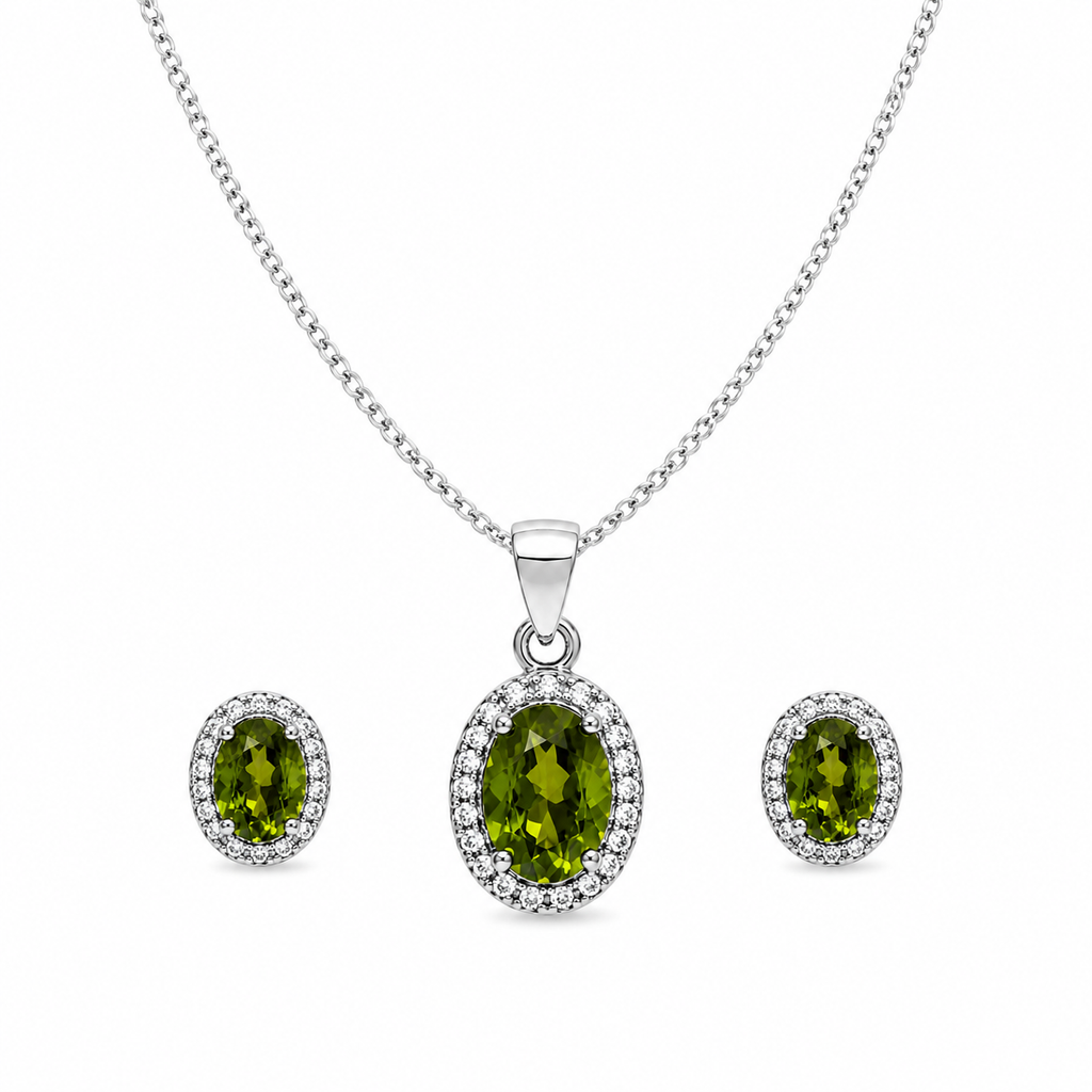 Green oval halo jewelry set featuring a sterling silver curb chain necklace with a sparkling oval green gemstone pendant and matching halo stud earrings on a pure white background.