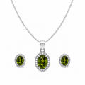 Green oval halo jewelry set featuring a sterling silver curb chain necklace with a sparkling oval green gemstone pendant and matching halo stud earrings on a pure white background.