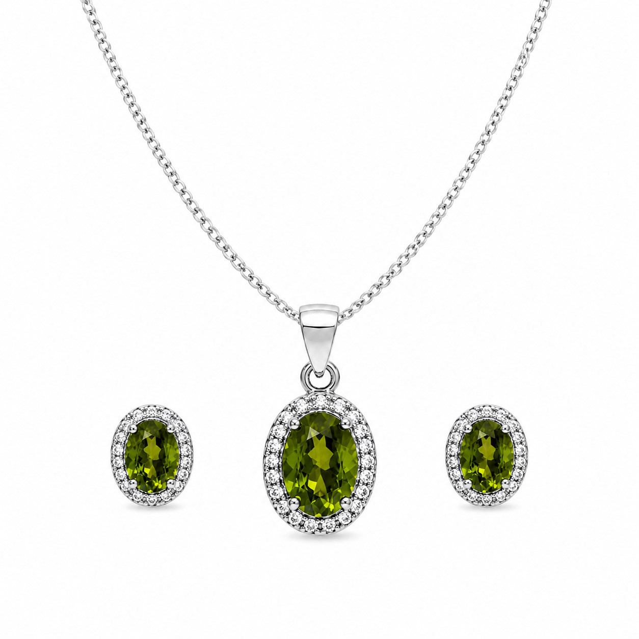 Green oval halo jewelry set featuring a sterling silver curb chain necklace with a sparkling oval green gemstone pendant and matching halo stud earrings on a pure white background.