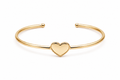 Polished gold heart cuff bracelet with an open bangle design displayed on a pure white background in a centered front view.