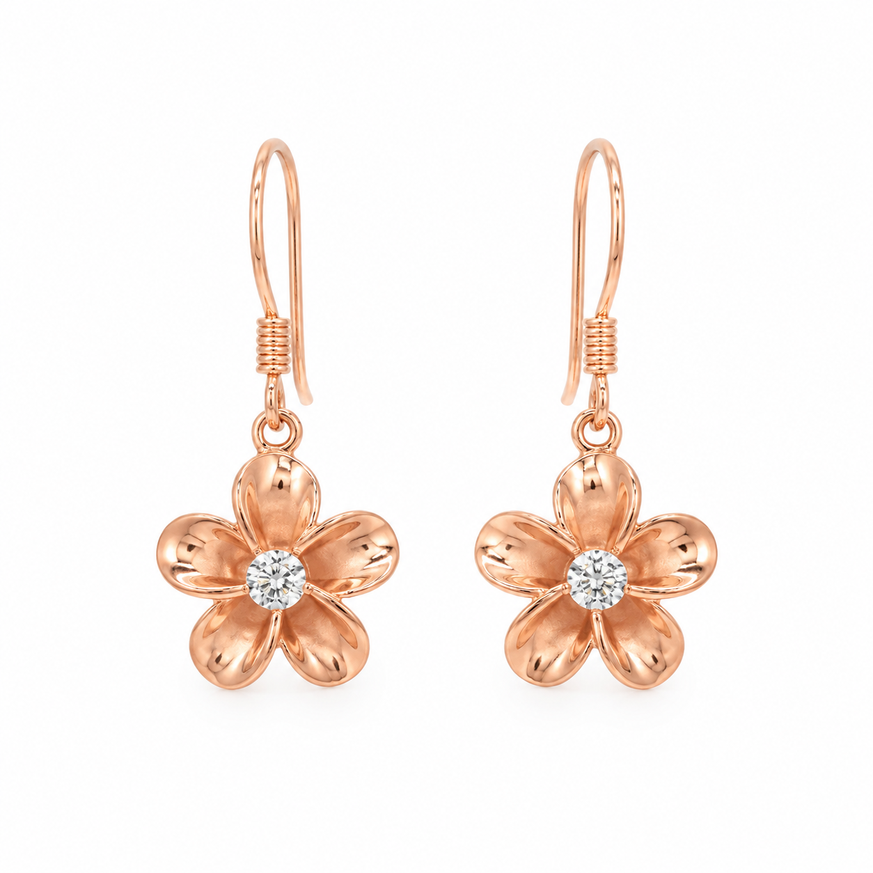 Rose gold plumeria flower drop earrings featuring polished five-petal blooms with sparkling clear center stones. The earrings hang from delicate fishhook wires and are displayed symmetrically on a pure white background, highlighting their tropical-inspired design and warm rose gold finish.