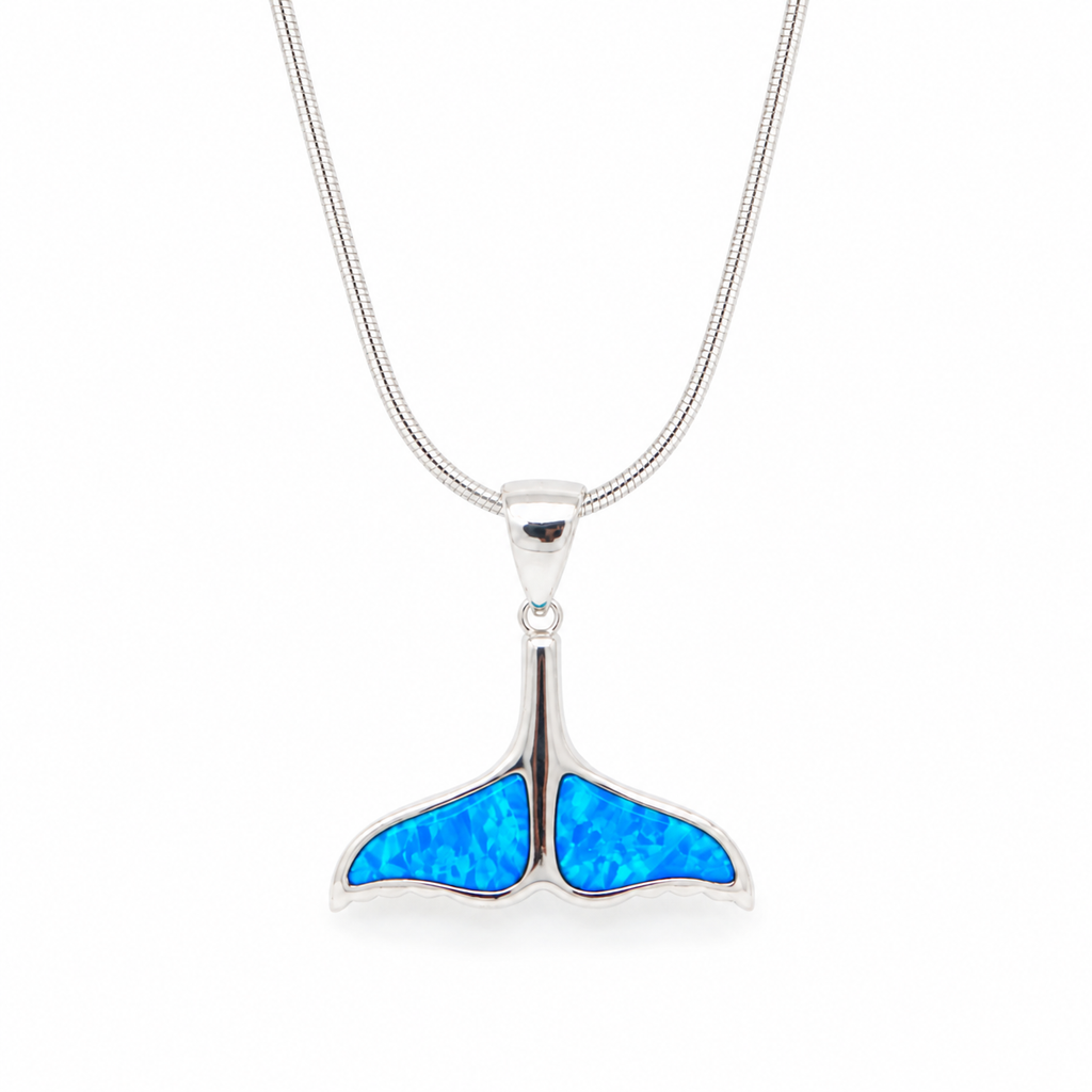 Sterling silver whale tail pendant necklace featuring a vibrant blue synthetic opal inlay on a polished silver snake chain. Elegant ocean-inspired jewelry for everyday wear, beach lovers, and Hawaii-inspired style.