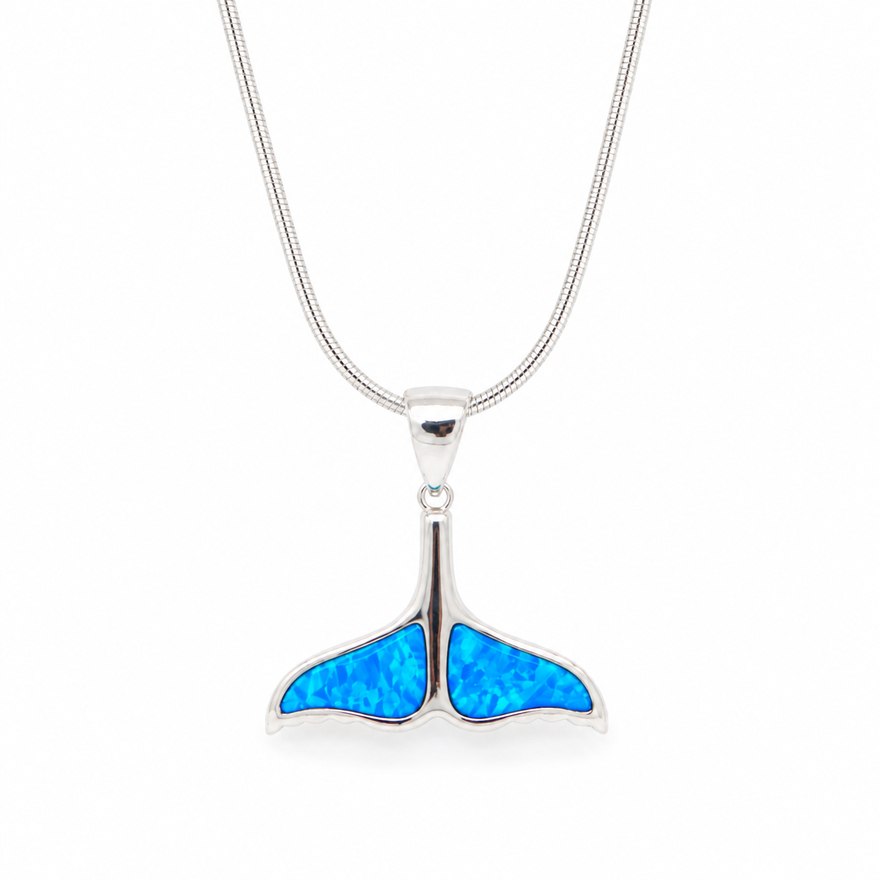 Sterling silver whale tail pendant necklace featuring a vibrant blue synthetic opal inlay on a polished silver snake chain. Elegant ocean-inspired jewelry for everyday wear, beach lovers, and Hawaii-inspired style.