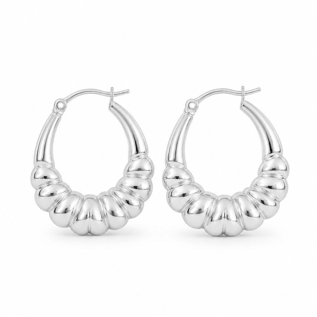 Pair of polished sterling silver chunky ribbed hoop earrings standing upright on a pure white background with a modern sculptural design.