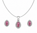 Sterling silver jewelry set featuring a pear-cut pink cubic zirconia halo pendant necklace on a thin curb chain with matching pink halo stud earrings on a pure white background