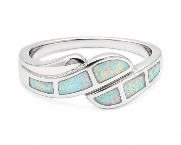 Polished silver wave ring featuring white synthetic opal inlay