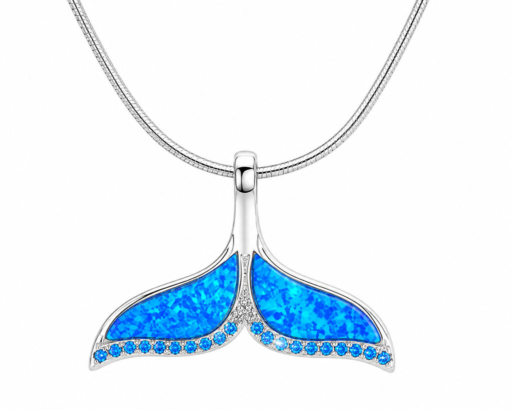 Coastal Whale Tail Necklace in sterling silver featuring a blue synthetic opal whale tail pendant with blue topaz accents on an 18 inch square snake chain, designed in Honolulu, Hawaii.