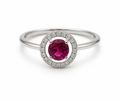 Silver ring with a red gemstone on a white background