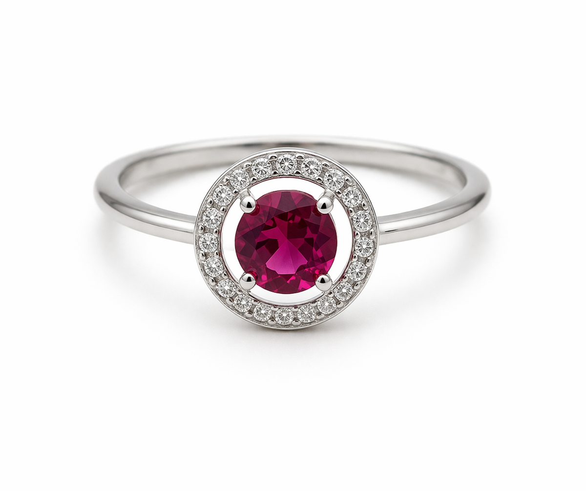 Silver ring with a red gemstone on a white background